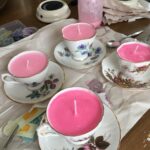 Alt text suggestion: Step-by-step guide on how to use the Wick Centering Device in candle making