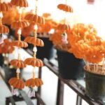 Hand-pouring wax into jars, making homemade soy candles with aromatic oils for a tranquil atmosphere