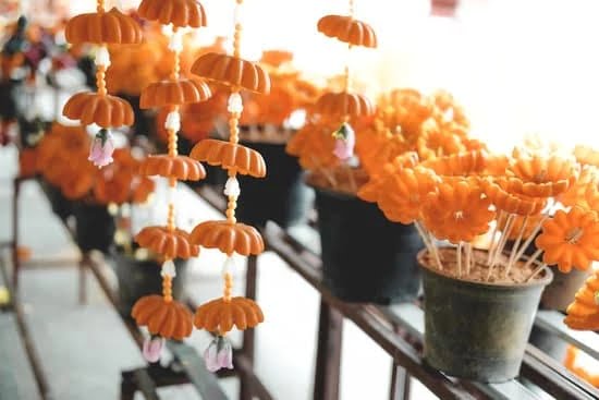 Hand-pouring wax into jars, making homemade soy candles with aromatic oils for a tranquil atmosphere