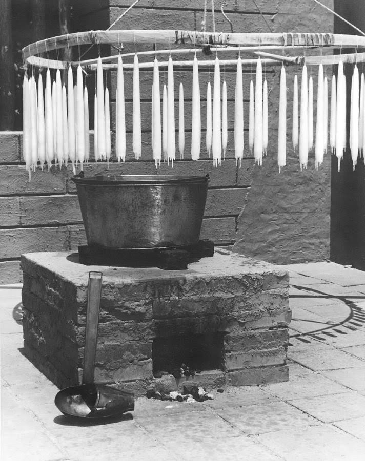 Hand carved candle making: skilled artisans crafting unique, intricate designs with precision and care