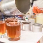 Aluminum candle making pouring pots on a wooden surface, ready for melting wax and pouring