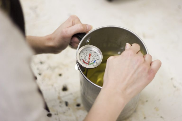 Crafting eco-friendly soy candles with aromatic essential oils to create calming ambiance